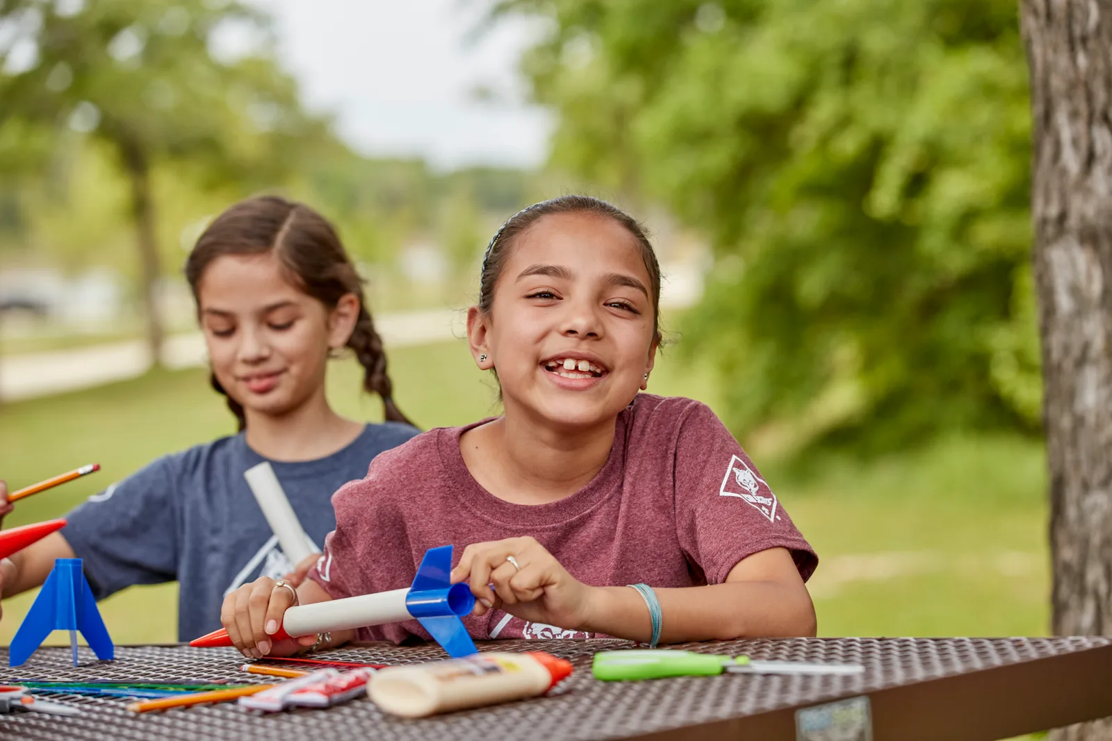 Two Cub Scouts building a model together at a picnic table